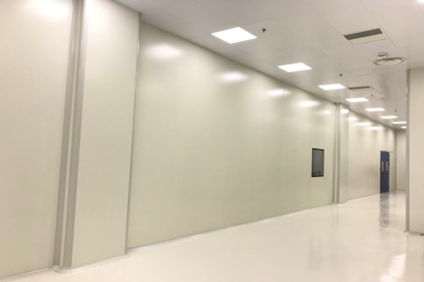 Wonclean real project photo showing cleanroom wall panel joints along a corridor beside cleanroom doors